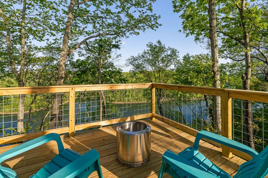 Deck with two chairs and a fire pit overlooking Center Hill Lake
