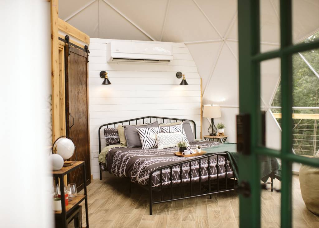 queen sized bed in a glamping dome