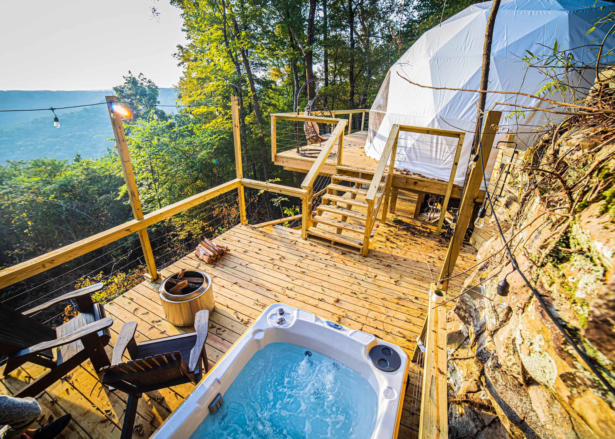 glamping dome and hot tub on a deck with mountain views