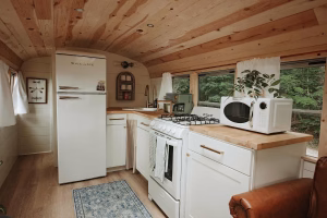The Skoolie's modern kitchen with new appliances