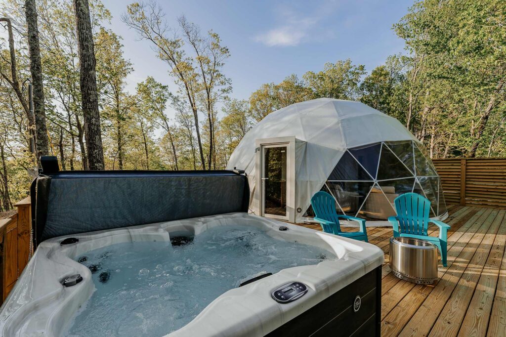 Outdoor hot tub and geodesic glamping dome on a private deck overlooking the woods at Center Hill Lake—perfect for relaxing after a day of fishing.