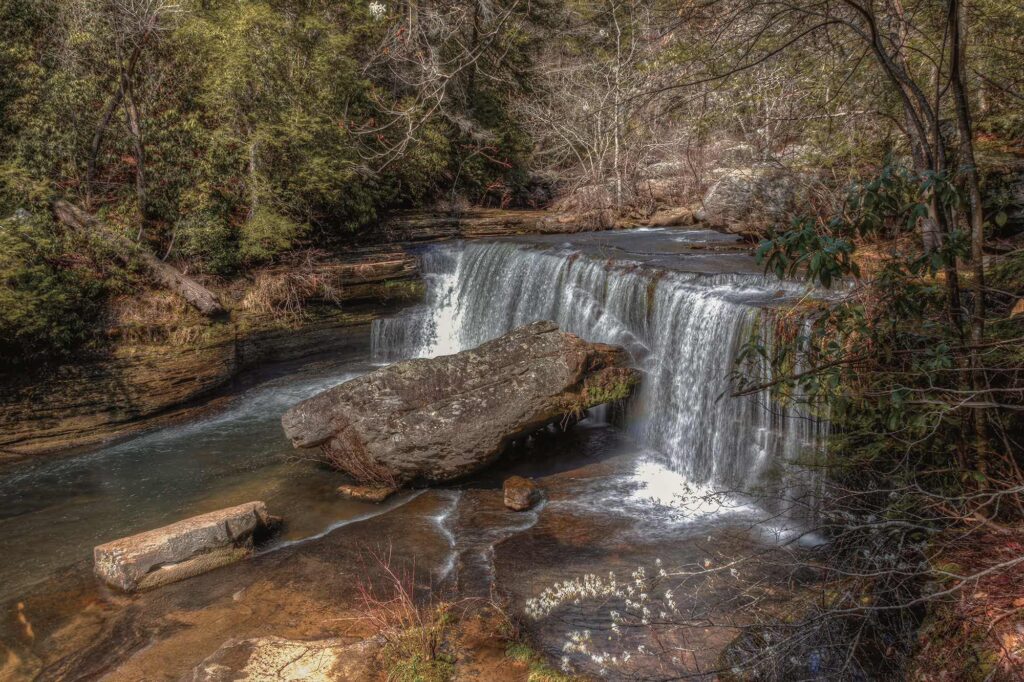 Upper Greeter Falls flows gently over a layered rock ledge in Savage Gulf Natural Area.